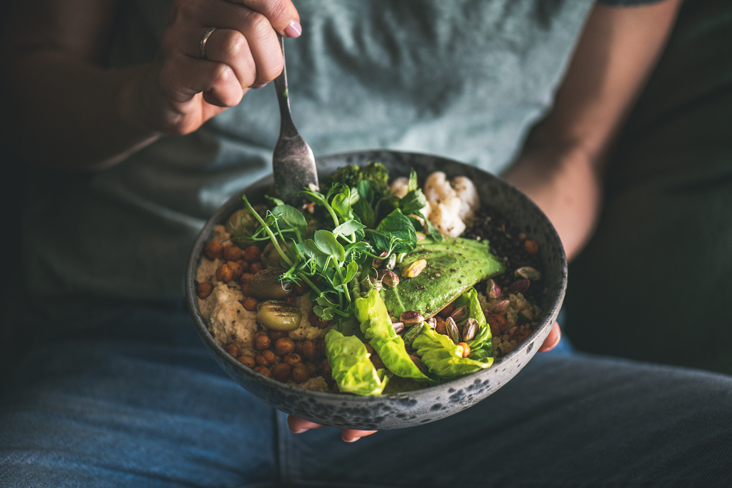 Woman eating healthy vegan dish from bowl